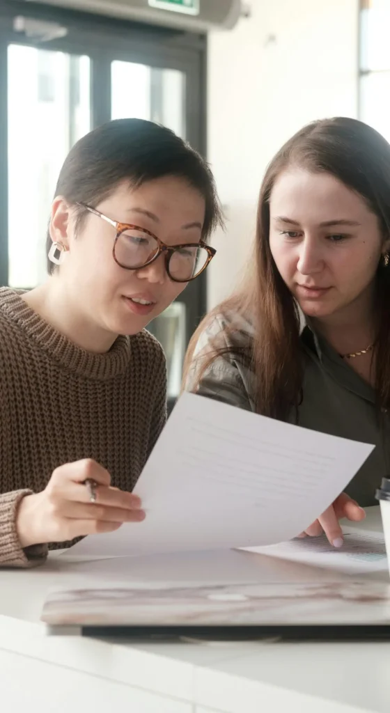 Female financial advisors reviewing information together