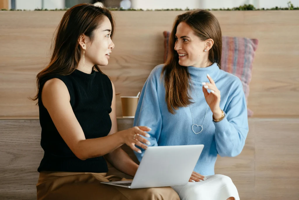 Two women discussing financial planning over coffee