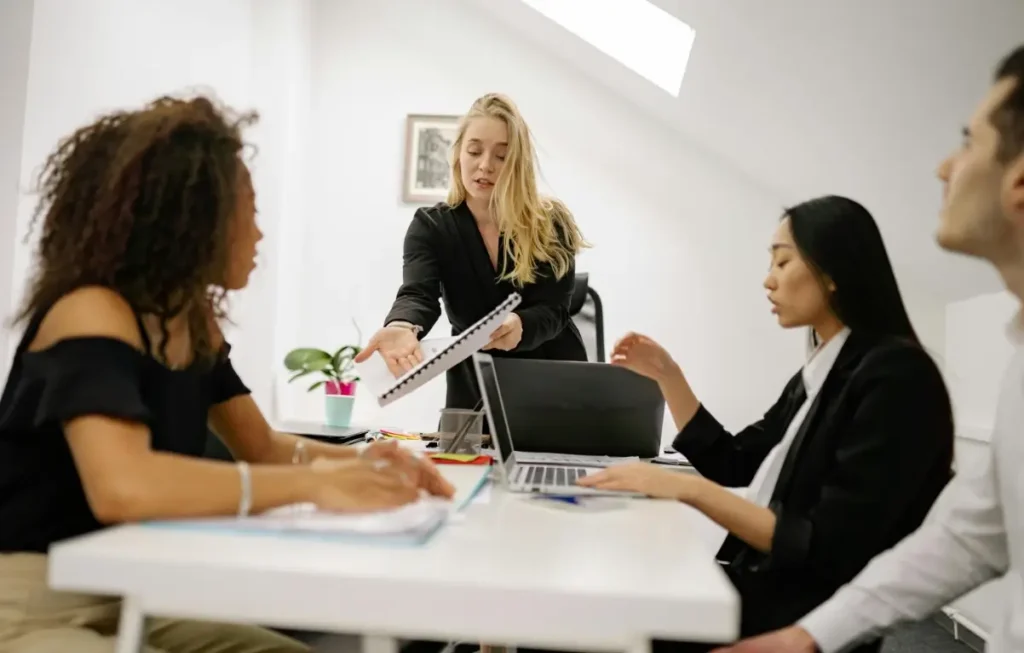 Female financial advisor presenting to colleagues
