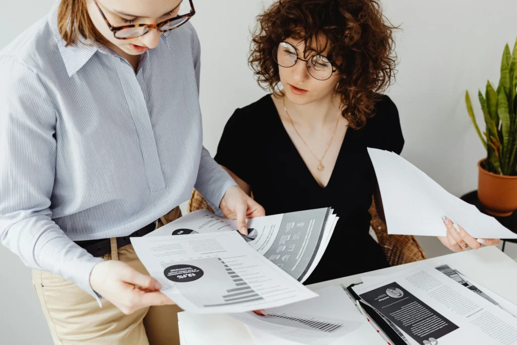 Women reviewing documents through a financial advisor support platform