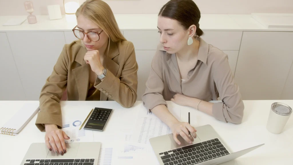 Two women financial planners reviewing work together