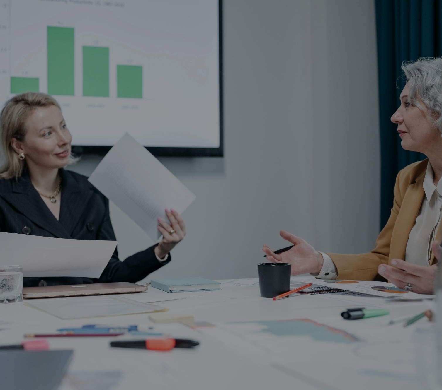 Women financial advisors discussing growth strategies